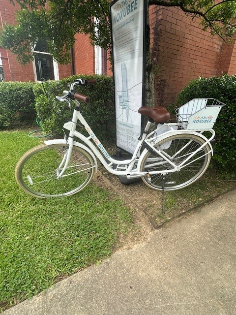 Bicycle Bicycle in front of a brick building and sign.